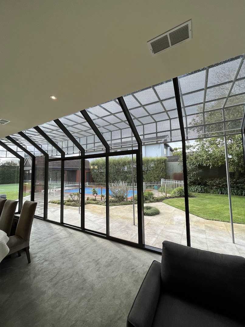 Pre-sale window cleaning Melbourne — floor-to-ceiling glass overlooking pool and garden