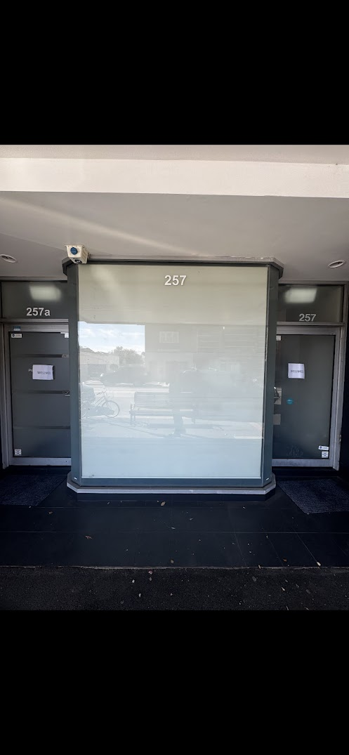 Shopfront covered in old window frosting — before